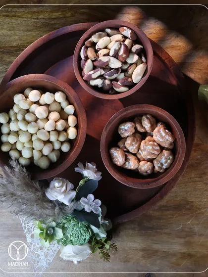 An overhead view of the wooden dry fruit serving set. The natural grain of the wood and the simple, elegant design make it a versatile piece for any home.