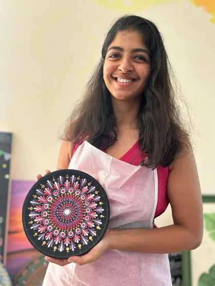 Look at that proud smile. This participant is holding her finished Dot Mandala plate, a beautiful and intricate piece she created dot by dot in one of my adult workshops.