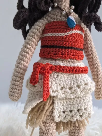 A detail shot of Moana's outfit, showing the layers of her skirt and the crochet textures.