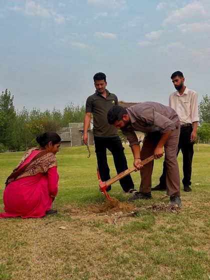 Preparing the ground for new growth. Our team works together to dig and plant during our environmental day activities, demonstrating that every small effort contributes to a larger positive impact.