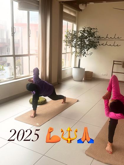 Two students hold a deep lunge, their focus and determination evident.