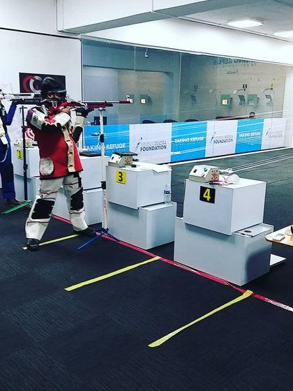Our shooters practicing at the range, which is set up to simulate international competition conditions, complete with branding from our foundation partners.