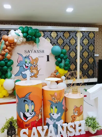 A classic Tom and Jerry themed party for Sayansh's first birthday. The setup includes a custom backdrop and themed pedestals featuring the iconic cartoon duo.