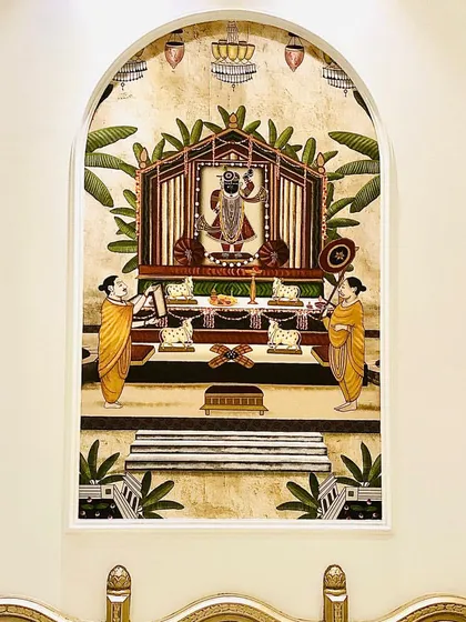 This beautiful archway frames a custom wallpaper depicting a traditional temple scene, creating a serene and spiritual focal point within the living area.
