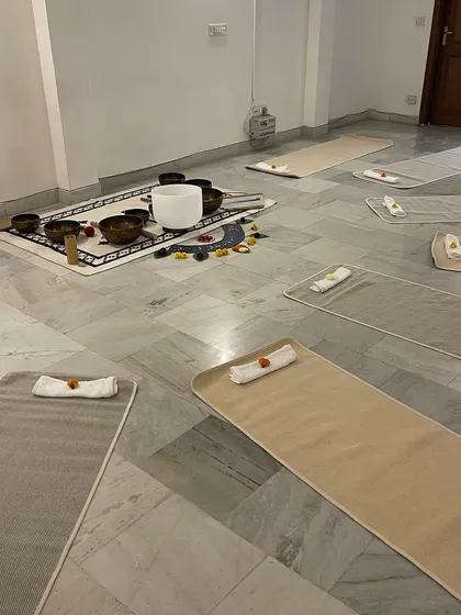 The serene setup for our Sound Healing workshop. We create a calm and inviting space with mats, bolsters, and singing bowls, ready for you to relax and receive the healing vibrations.