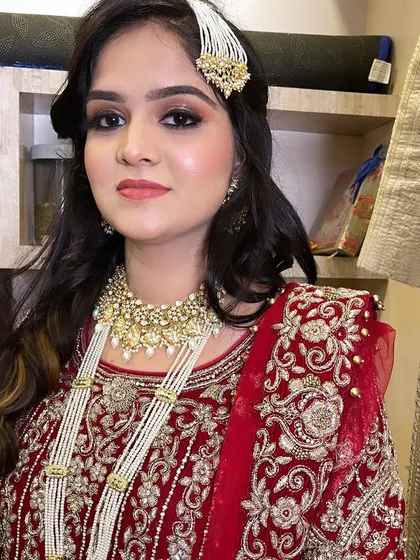 Our gorgeous client, all dolled up. This photo showcases the final look, a perfect balance of traditional attire and soft, elegant makeup.