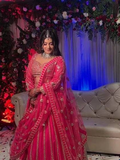A close-up of the bride at the ring ceremony, with the detailed floral decor visible in the background.