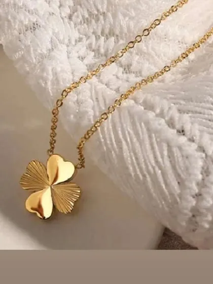 A close-up of my popular four-leaf clover necklace. This piece is crafted from high-quality, gold-toned stainless steel that is guaranteed to keep its color, making it a perfect lucky charm for everyday wear.