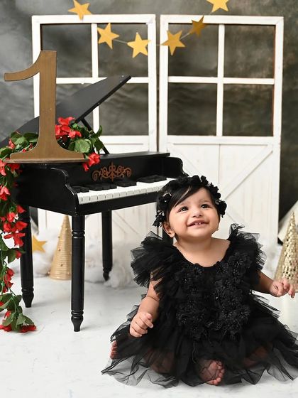 A smile that shines as bright as the stars. This little pianist is enjoying her moment in the spotlight during her elegant, celestial-themed shoot.