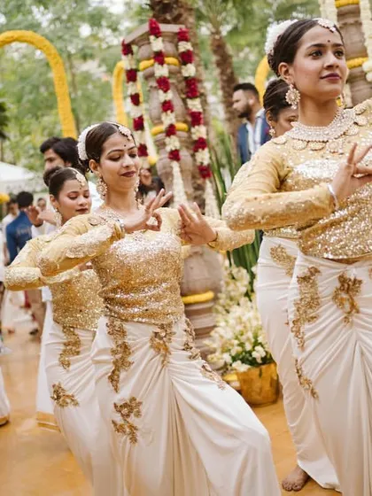 Dancers in beautiful white and gold costumes performing a traditional dance, adding grace and elegance to the event.