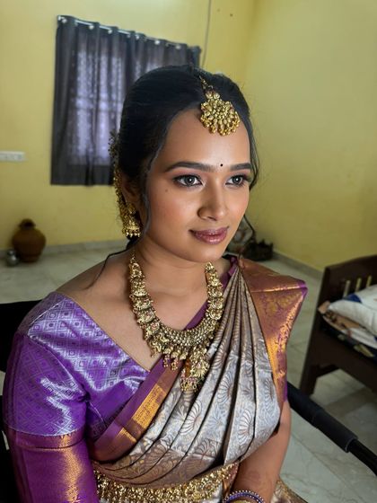 A close-up of Swathy's engagement makeup. The look is soft and romantic, with a focus on flawless skin and subtly defined eyes, perfect for a pre-wedding celebration.
