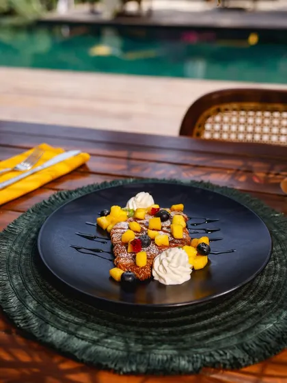 Our fruit-topped croissant served on the deck, a mindful indulgence to start your day.