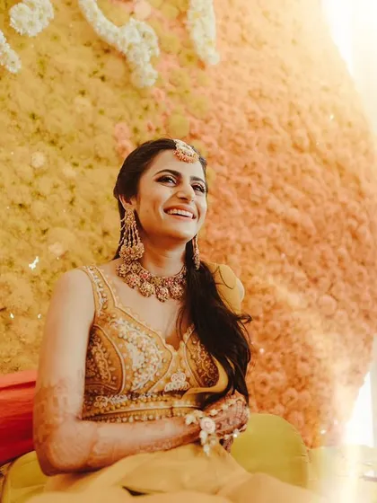 The bride's radiant smile is the best compliment to our classic genda phool decor.