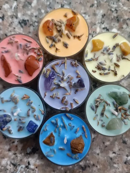 This is my popular 7 Chakra healing candle set, shown here as tealights. Each candle is colored and infused with a specific crystal and botanical blend, like lavender, to correspond with each chakra for balancing rituals.