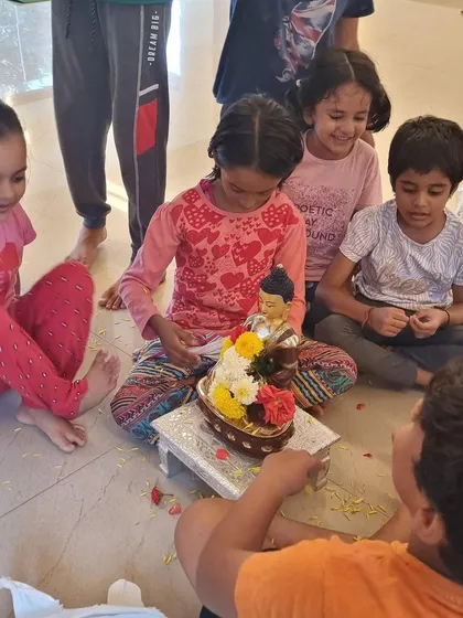 Another view of the children's flower offering. Their smiles show that acts of devotion can be filled with lightness and joy.