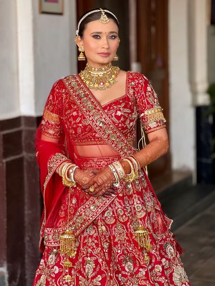 A full-length view of this classic red bride. The makeup is designed to be flawless from every angle, ensuring she looks perfect in person and in every photo.