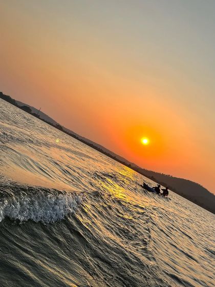The waves from a passing boat add a little excitement to a peaceful sunset kayaking trip.
