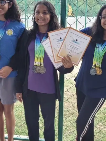 Displaying their haul of medals and certificates. These swimmers put in the hours, and it's rewarding to see their efforts pay off in such a big way.