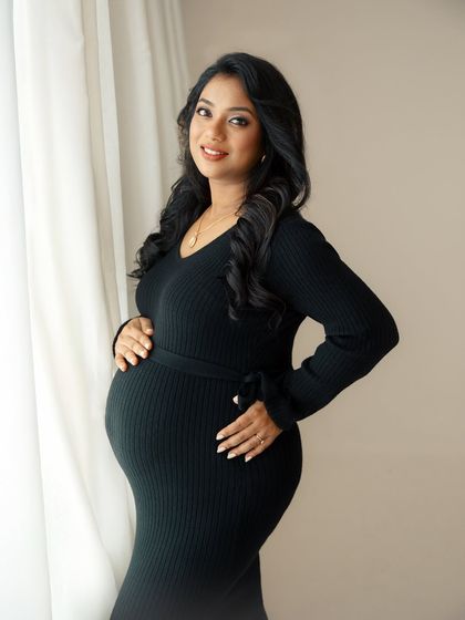 A simple, elegant portrait by the window. I guide my clients into comfortable poses that feel natural, resulting in authentic photos that capture their true glow.