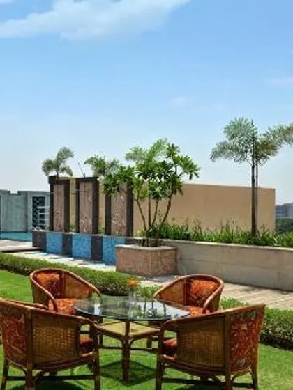 A rooftop can become a functional and beautiful lawn with a view. This project demonstrates our ability to create lush, green turf areas in urban high-rise environments, complete with curated trees and shrubs in stone planters, offering a classic garden experience elevated above the city.