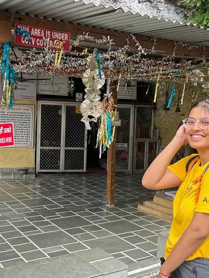 A student at a local temple during our Rishikesh YTTC. The training goes beyond the mat, incorporating cultural and spiritual immersion.