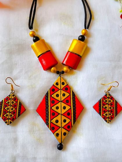 This version of the diamond-pendant necklace comes in a striking red and yellow. The bold colors make a statement, while the design remains sleek and modern.