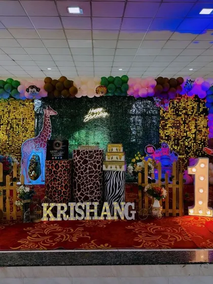 Welcome to the jungle! This safari-themed birthday party stage shows how I layer different textures, from a green foliage wall and sequin panels to animal-print pedestals. The light-up marquee number and custom name sign make it a personalized adventure.