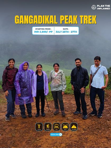 A group of trekkers in raincoats on the Gangadikal Peak trail, ready for a monsoon adventure.