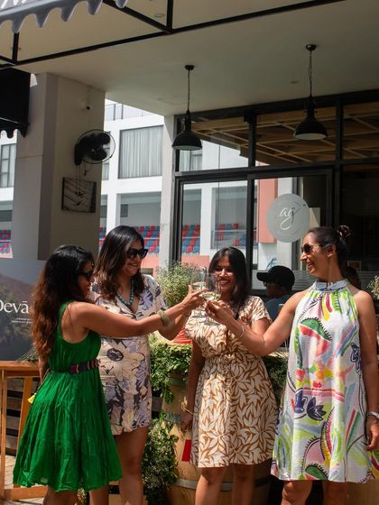 Cheers to good times. Guests enjoying a toast at our sunny Wine Picnic.