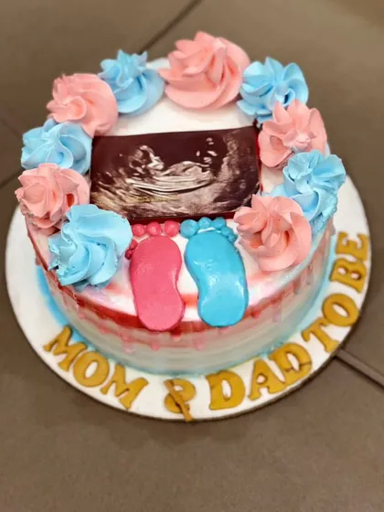 Announce your joy in the sweetest way possible. This pregnancy reveal cake was designed for expecting parents, featuring an edible print of their baby's ultrasound photo, surrounded by pink and blue frosting to build excitement.