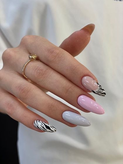 Mixing it up with this set that combines solid pastel nails with bold zebra print accent nails.