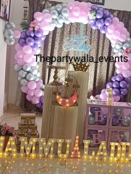 A beautiful pastel purple and pink balloon ring with silver accents. The light-up name sign is extra long, perfect for celebrating twins or two names.