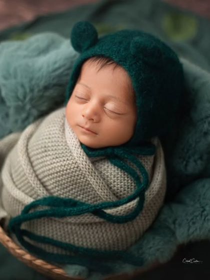 So cozy in his little bear bonnet. This basket pose is perfect for capturing a sleeping baby from above, showing off their sweet face and cute accessories.