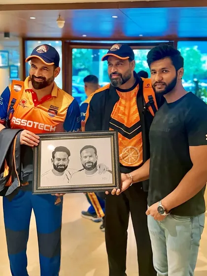 A photo with the Pathan brothers, Irfan and Yusuf, after gifting them a joint portrait. Two legends in one frame.
