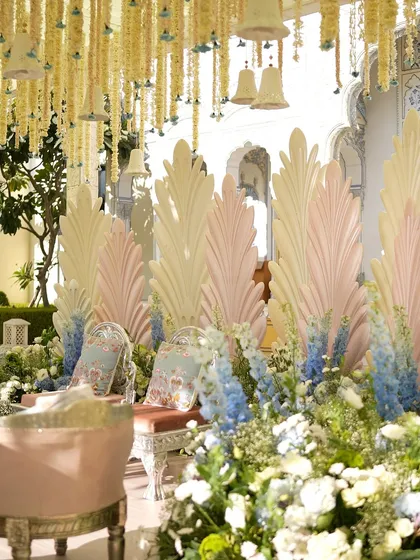 A wider view of the stunning mandap, surrounded by a garden of pastel flowers.