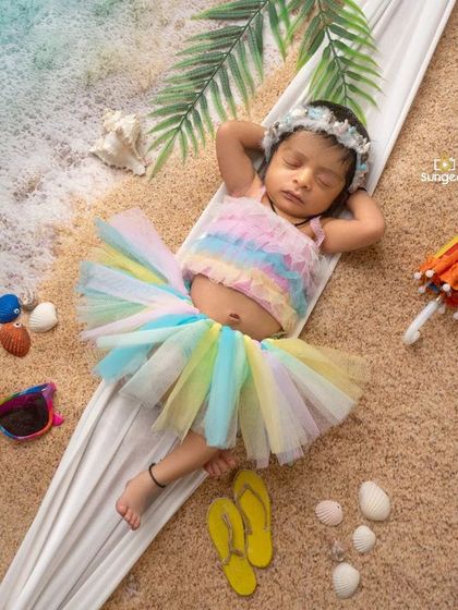 Relaxing in a hammock on a warm, sandy beach. This newborn beach theme is one of our most popular creative setups, perfect for capturing a relaxed and happy vibe.
