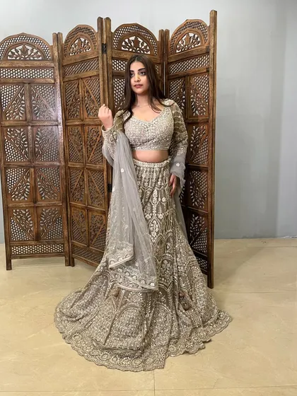 This grey lehenga with heavy silver embroidery is a sophisticated and modern choice for any party.