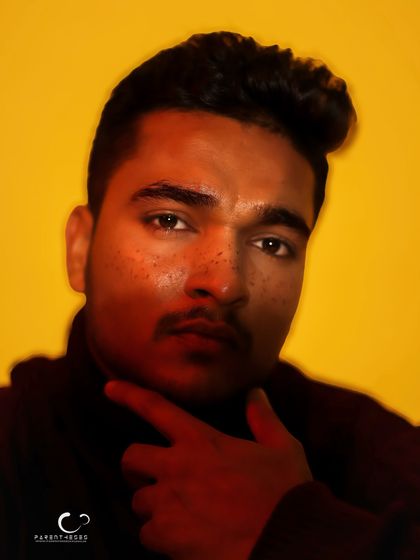 A close-up male portrait with a motion blur effect, rendered in high-contrast color. The freckles and intense gaze are highlighted by the dramatic lighting.