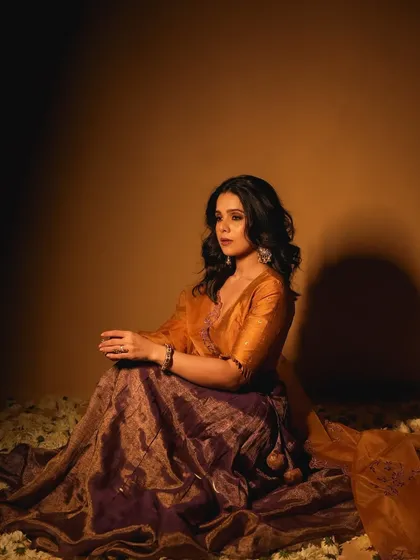The lighting in this shot creates a beautiful, painterly effect. The makeup holds up perfectly, with the skin looking luminous and smooth.