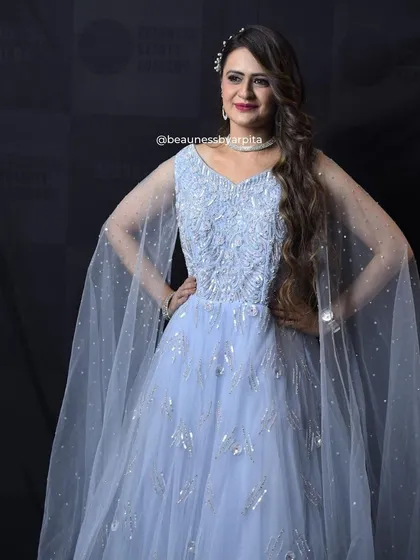 A full-length view of the elegant powder blue gown. The flowing fabric and delicate details make it a dream outfit for any grand event.