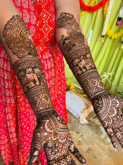 This design features a prominent peacock on the back of the arm, with its feathers flowing down into the rest of the pattern.