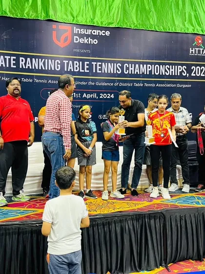 A young spectator watches as our players receive their awards. This inspires the next generation of players to aim high and work towards their own goals in table tennis.