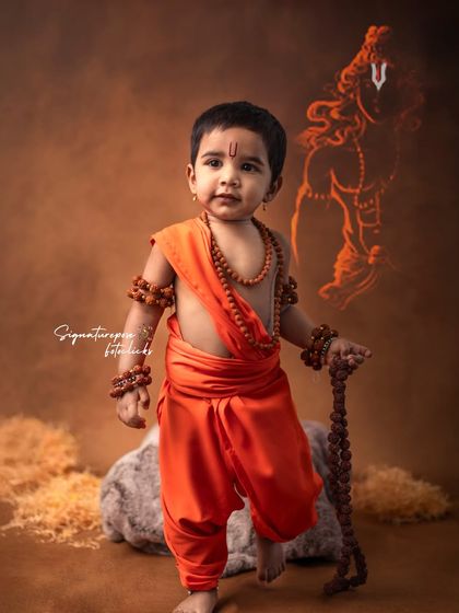 A powerful stance from a young boy portraying Lord Rama, with an artistic sketch in the background adding a layer of depth and storytelling.