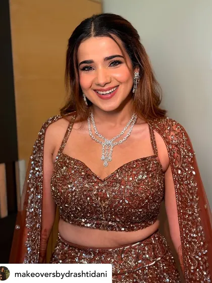 This bride looks absolutely stunning for her Sangeet night. I created a warm, bronzy glam look with a sparkling eye to match her heavily embellished lehenga.