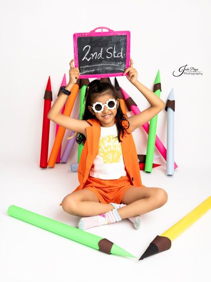 Proudly announcing she's in the 2nd standard. Using a small chalkboard is a great way to personalize the shoot and mark the specific milestone.