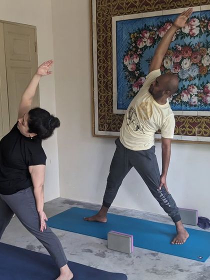 Beautiful memories from a yoga retreat. Here, students are practicing side angle and triangle poses, finding alignment and joy together.