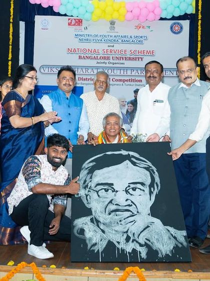 Presenting my completed live portrait to the Vice-Chancellor of Bangalore University during the India Youth Parliament event.