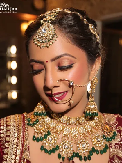 A close up of a happy bride with her eyes closed, showcasing the detailed eye makeup. I used a classic winged liner and warm eyeshadow tones, paired with a rich berry lip, to create a look that is both glamorous and traditional.