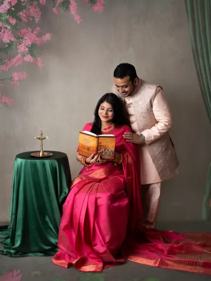 A portrait that feels like a timeless painting. We worked with this couple to create a traditional maternity look, using a vibrant pink saree and classic props like a brass lamp to celebrate their cultural roots.