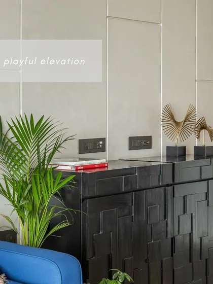 We believe storage should be both smart and stylish. This custom black cabinet features a playful, geometric pattern on its shutters, turning a functional piece into a sculptural element in the room.